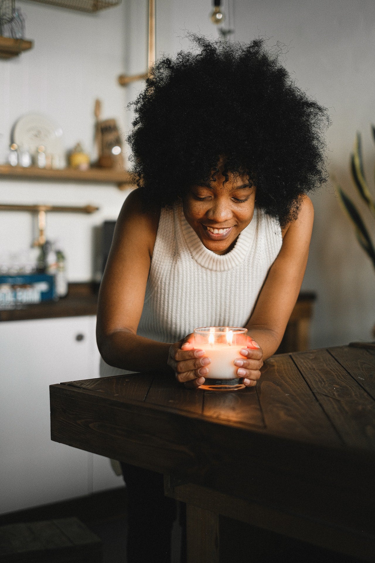woman with aromatic candle at home