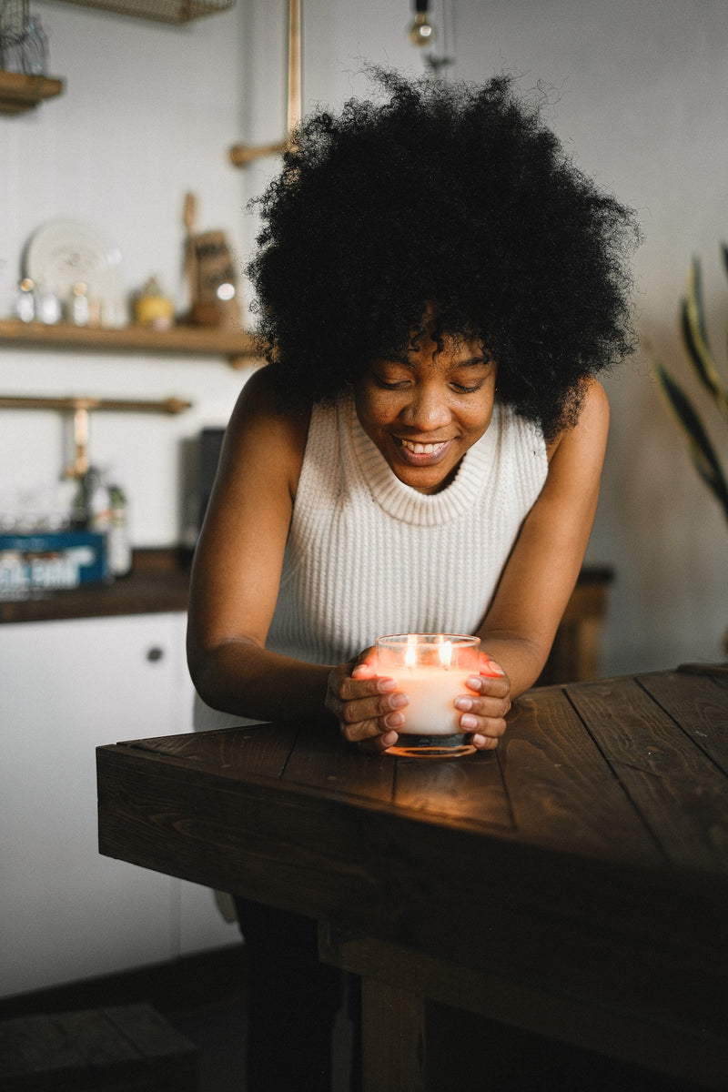 woman with aromatic candle at home